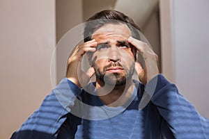 Depressed man sitting on floor