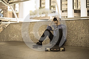 Depressed man sitting on floor head in hands