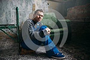 Depressed man sitting on the floor, psycho patient