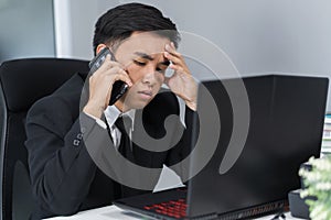Depressed man in suit talking on smartphone