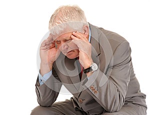 Depressed mature businessman holding head