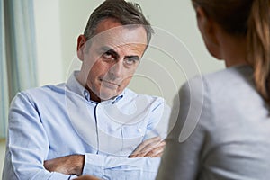 Depressed Mature Man Talking To Counsellor