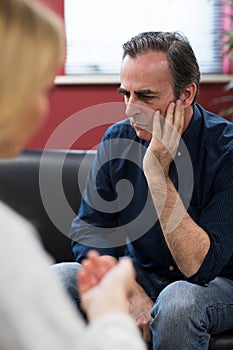 Depressed Mature Man Talking To Counselor