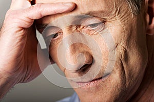 Depressed mature man touching his head