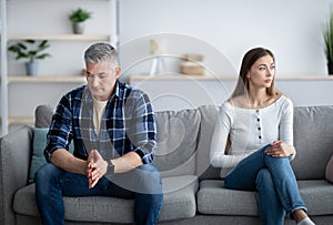 Depressed mature man and woman having relationship problems, going through marital crisis at home