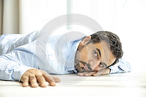 Depressed middle aged arab man on a floor