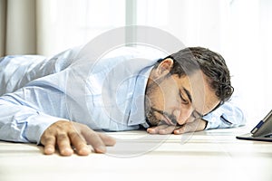 Depressed middle aged arab man on a floor