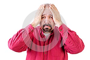 Depressed middle aged man with head in hands