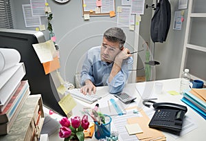 Depressed office worker at his desk