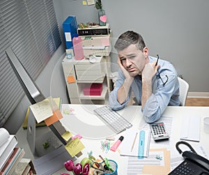 Depressed office worker at his desk