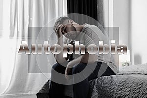 Depressed overweight man sitting alone on bed. Autophobia