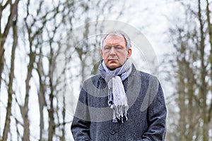 Depressed or sad man walking in winter