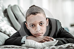 Depressed sad young boy looking at you