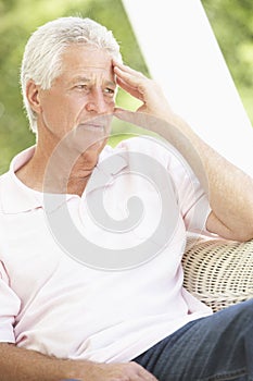 Depressed Senior Man Sitting In Chair