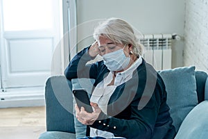 Depressed senior woman with facemask feeling lonely after loosing husband due to coronavirus