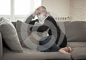 Depressed senior woman with facemask feeling lonely after loosing husband due to coronavirus