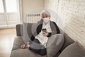 Depressed senior woman with facemask feeling lonely after loosing husband due to coronavirus