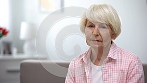 Depressed senior woman looking at camera, social insecurity, low incomes photo