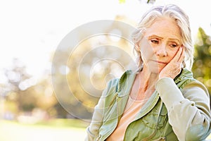 Depressed Senior Woman Sitting Outside photo