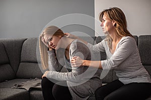 Depressed teen suffering from anxiety being taken care of by her mother