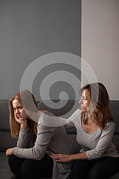 Depressed teen suffering from anxiety being taken care of by her  mother photo