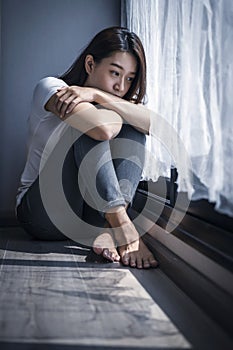 Depressed teenage girl sitting alone