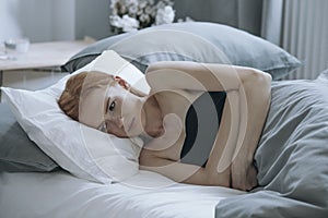 Depressed teenager lying in bed