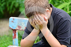 Depressed teenager sitting on the bench