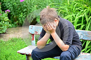 Depressed teenager sitting on the bench