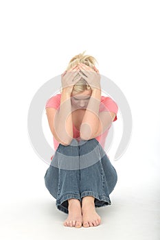 Depressed Thoughtful Unhappy Young Woman Sitting Alone on the Floor