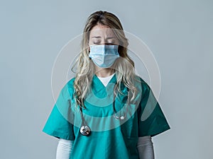 Depressed and tired female Doctor or Nurse Wearing Protective Medical Face Mask portrait