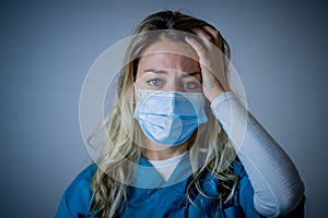 Depressed and tired female Doctor or Nurse Wearing Protective Medical Face Mask portrait