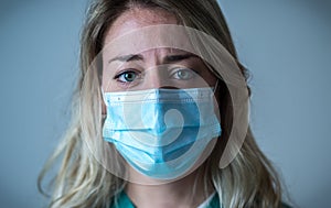 Depressed and tired female Doctor or Nurse Wearing Protective Medical Face Mask portrait