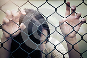 Depressed, trouble and solution. Hopeless women hand on chain-link fence.