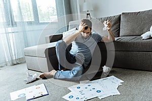 Depressed unhappy man crumpling paper