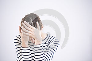 Depressed woman against white background