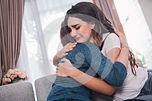 Depressed woman being embrace by her friend