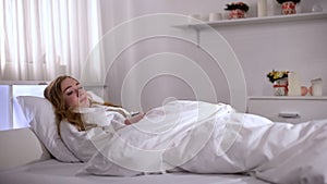 Depressed woman crying in bed, feeling offense and humiliation, break up