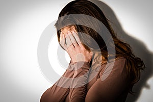 Depressed woman with head in hands