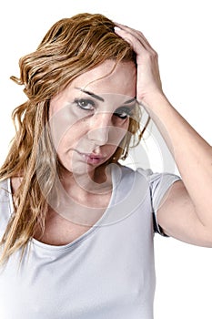 Depressed woman looking desperate in pain face expression suffering migraine and headache