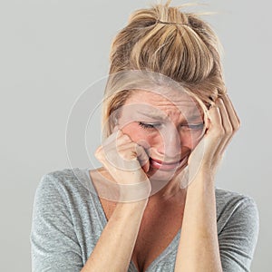 Depressed woman in pain expressing regret and sadness photo