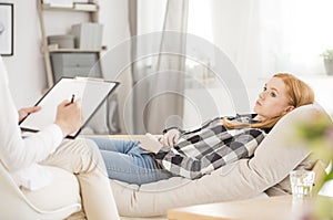 Depressed woman during psychotherapy session photo