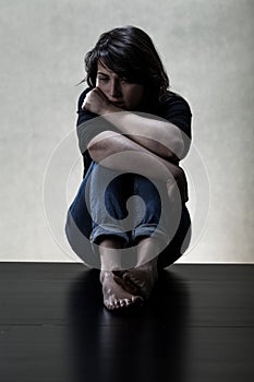 Depressed woman sitting on the floor