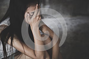 Depressed woman sitting on ground, Fear, loneliness, depression, abuse, female in depression sadness in dark tone