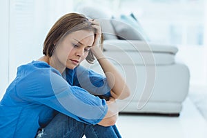 Depressed woman sitting at home