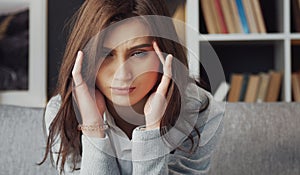 Depressed woman touching temples headshot