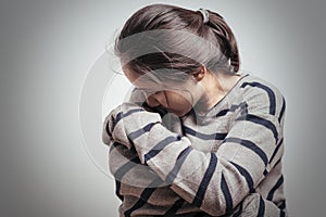 Depressed women sitting in the dark room, alone, sadness, emotional concept