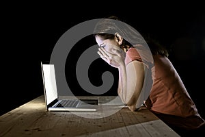 Depressed worker or student woman working with computer alone late night in stress