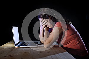 Depressed worker or student woman working with computer alone late night in stress