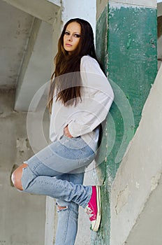 Depressed young girl in the abandoned building